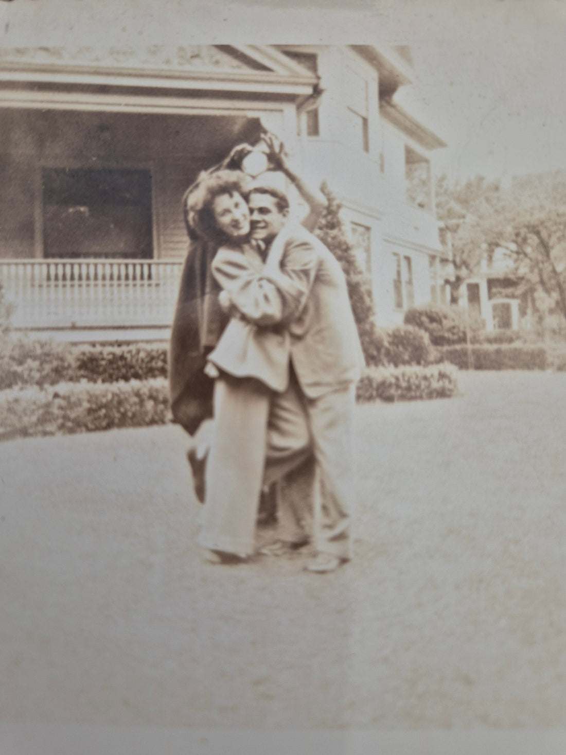 My grandparents dancing and laughing out the front of my pop's house in America — pure joy, captured in the 1940s.