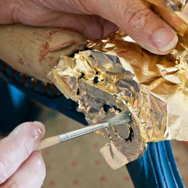 Annie applying gold leaf