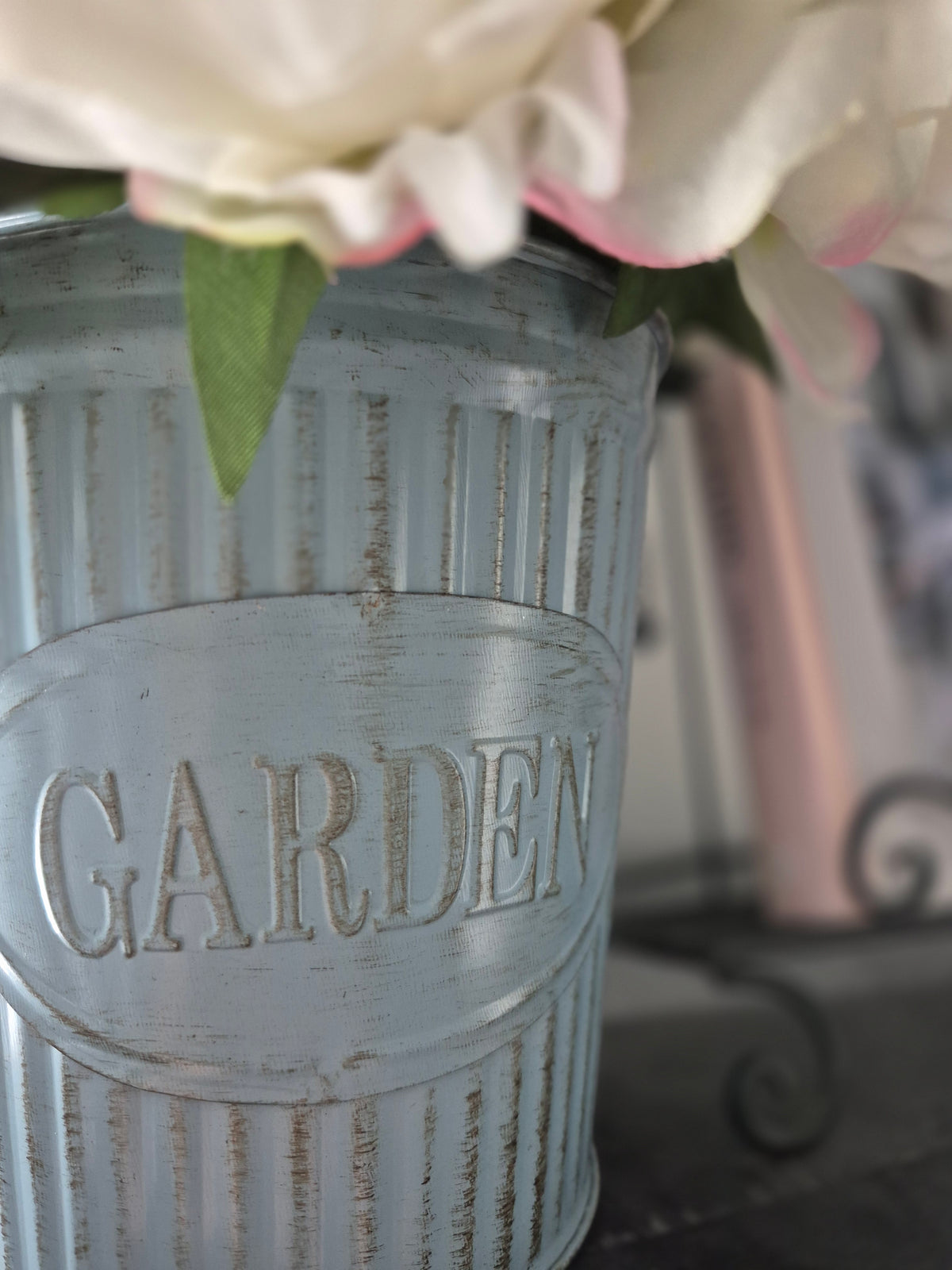 Styled detail from The Curated Life Journal Issue 2 — chalk-painted pale blue ribbed tin vase with white roses