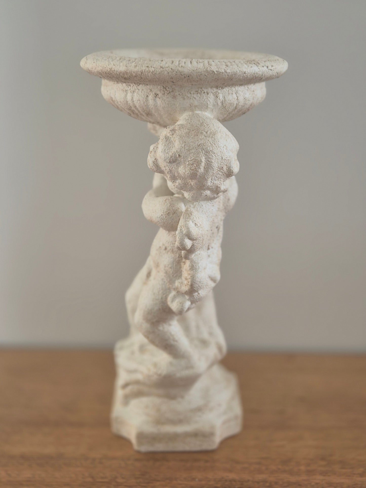 Cherub pedestal birdbath stone finish side profile