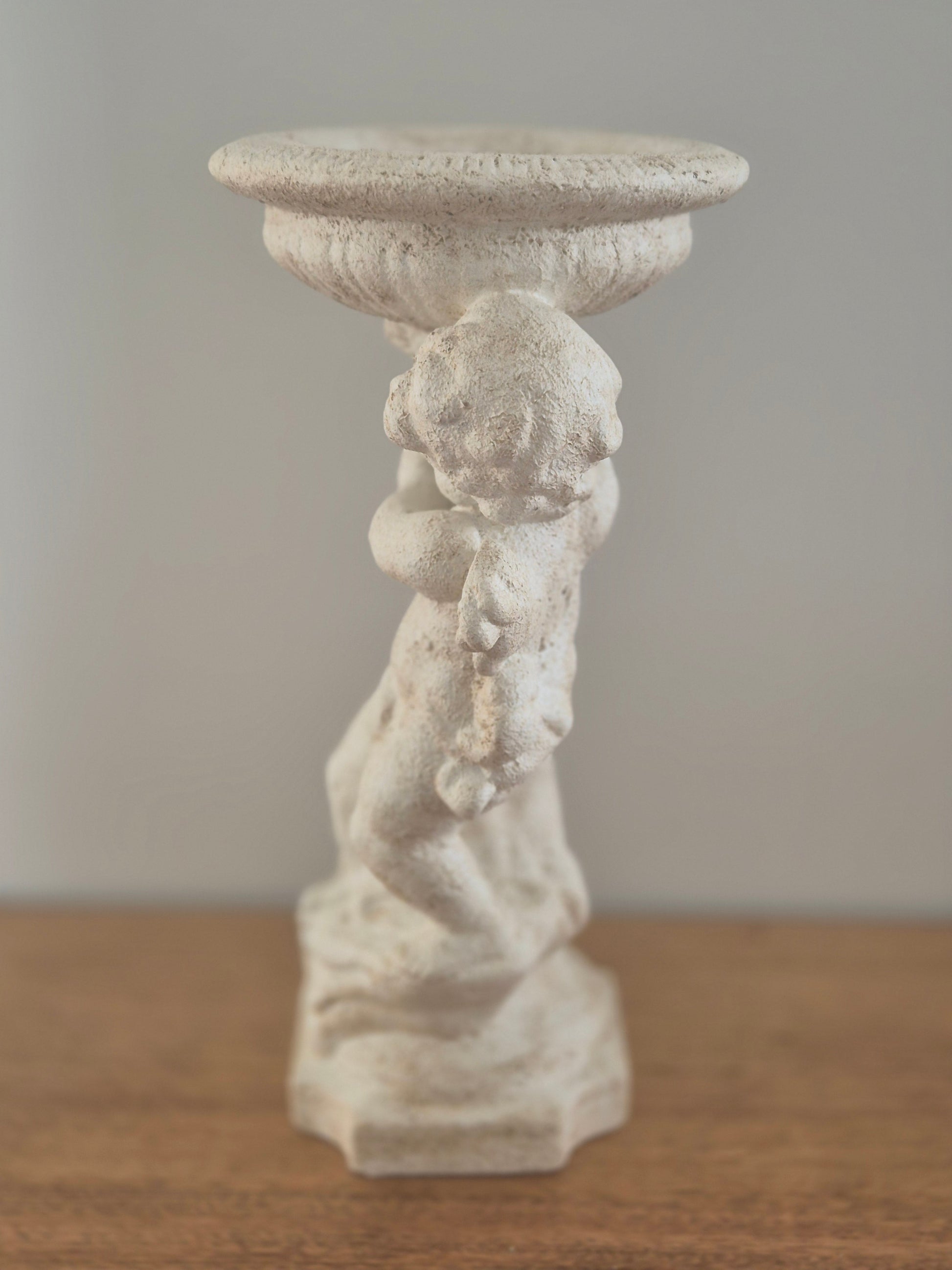 Cherub pedestal birdbath stone finish side profile